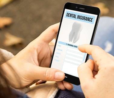 Patient looking at dental insurance form on phone