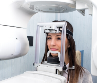 Dental patient receiving a C T cone beam scan of her mouth