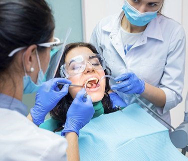 Woman getting a filling placed