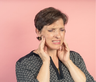 Older woman holding her jaws in pain