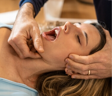 Dentist adjusting a patients jaw