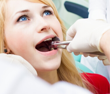 Young dental patient having her wisdom tooth extracted